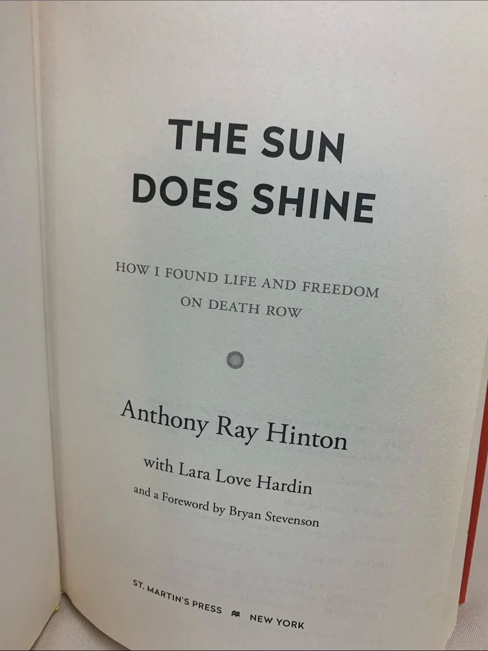 The Sun Does Shine by Anthony Ray Hinton — Orange Hardcover Book